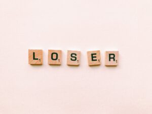 closeup photography of loser scrabble letter